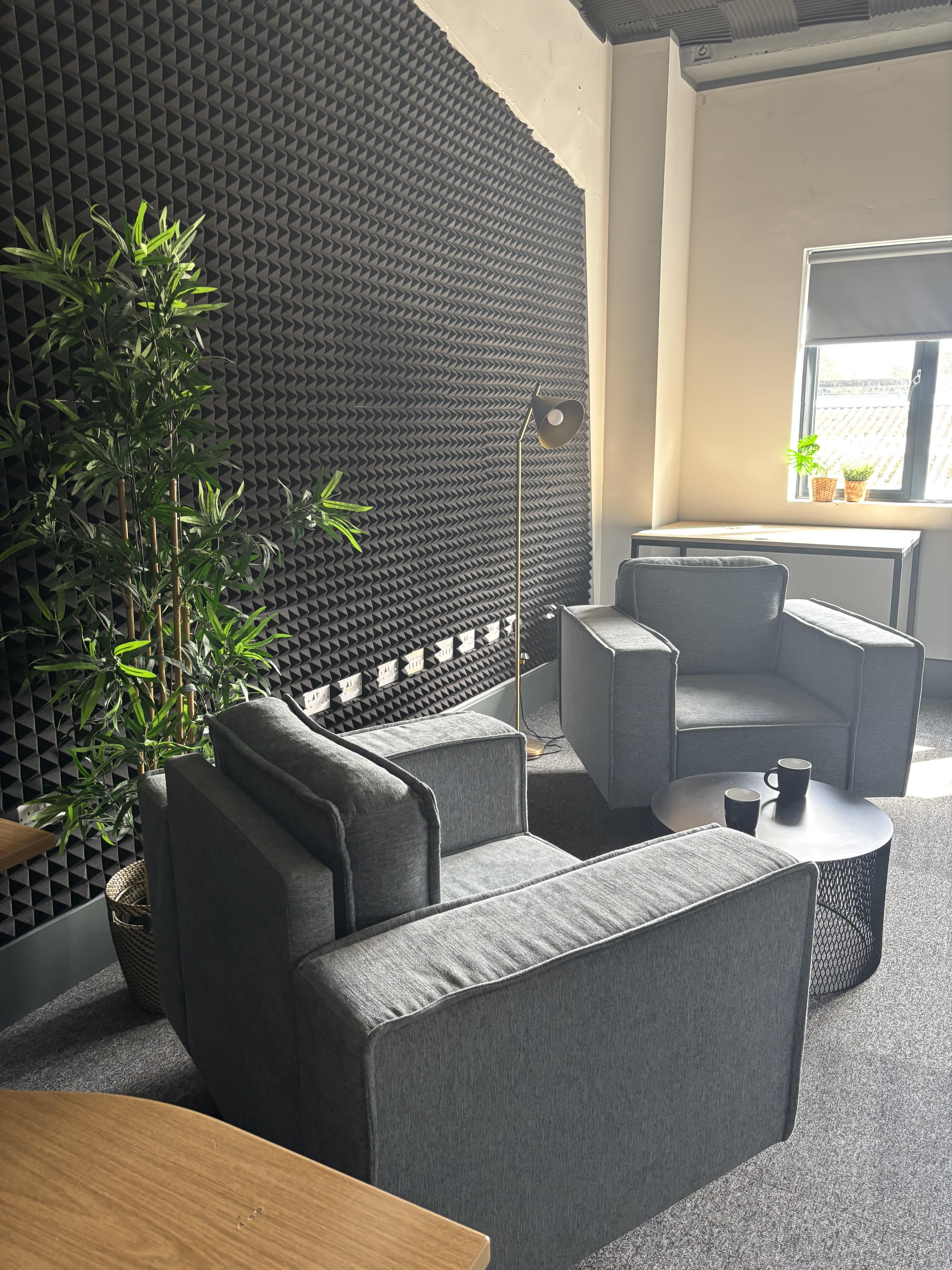 Comfortable lounge and meeting area with armchairs and a coffee table
